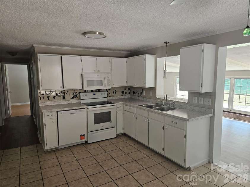 2782 West View Street, Hickory, NC 28601.  MLS# CAR4428982, YatesRealty ID 53390. Kitchen with new dishwasher and microwave