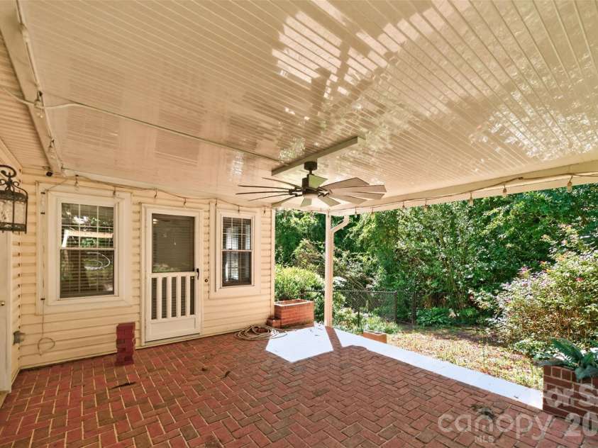 1058 13th Avenue Place, Hickory, NC 28601.  MLS# CAR4429107, YatesRealty ID 53463. Back covered brick patio with lighting and fan.