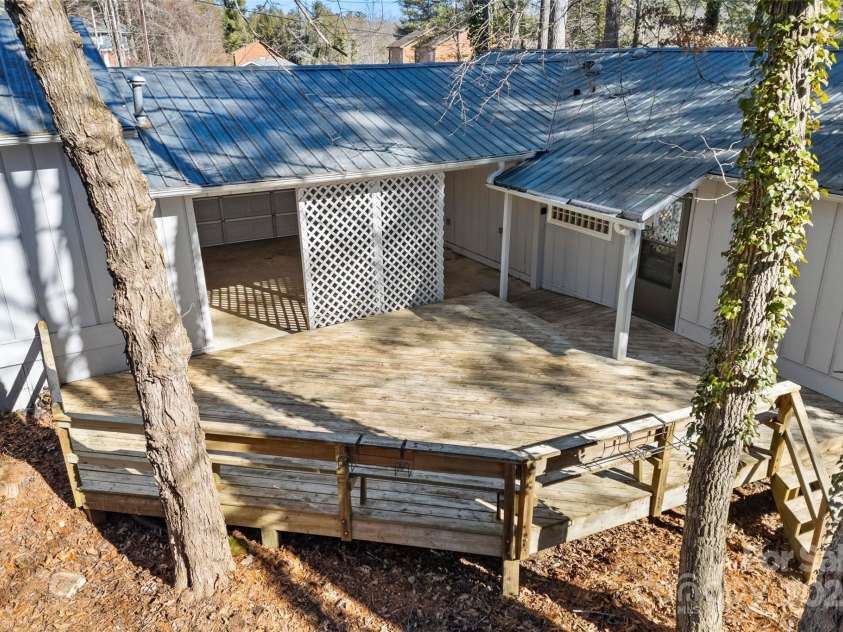 550 Kinross Drive, Flat Rock, NC 28731.  MLS# CAR4215035, YatesRealty ID 535. Deck off front porch/ behind carport