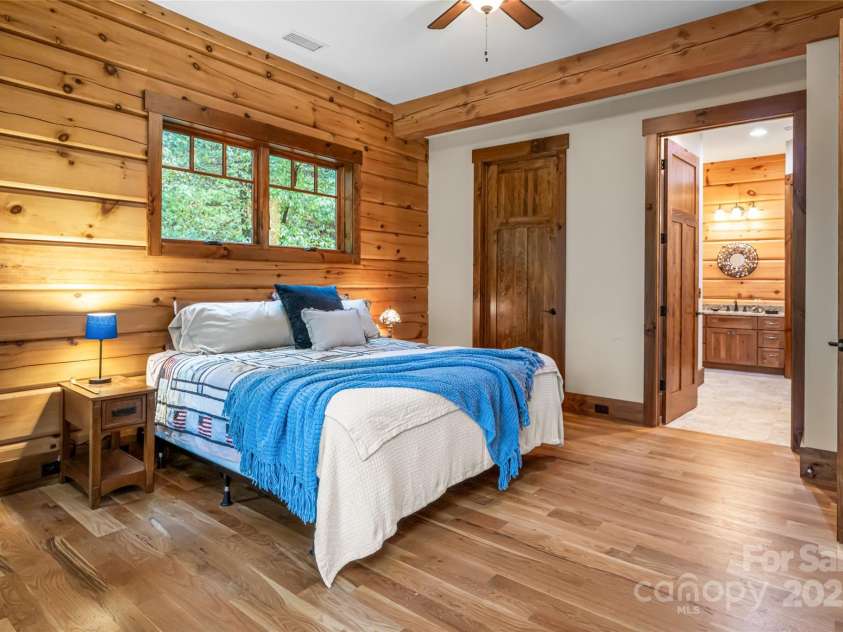 635 Whisper Mountain Drive, Leicester, NC 28748.  MLS# CAR4302796, YatesRealty ID 5352. Main-level primary suite with private deck access + serene mountains