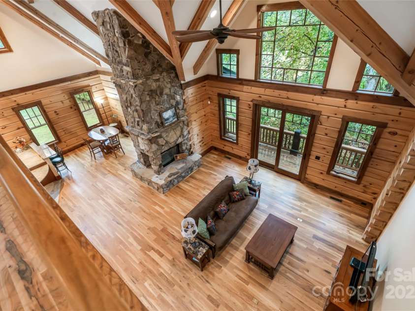 635 Whisper Mountain Drive, Leicester, NC 28748.  MLS# CAR4302796, YatesRealty ID 5352. Soaring great room with stone fireplace + large windows for natural light