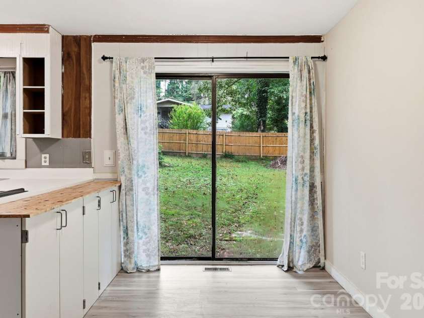 36 Medlin Lane, Flat Rock, NC 28731.  MLS# CAR4428597, YatesRealty ID 53594. Bright kitchen and dining space with ample natural light and views of the backyard.