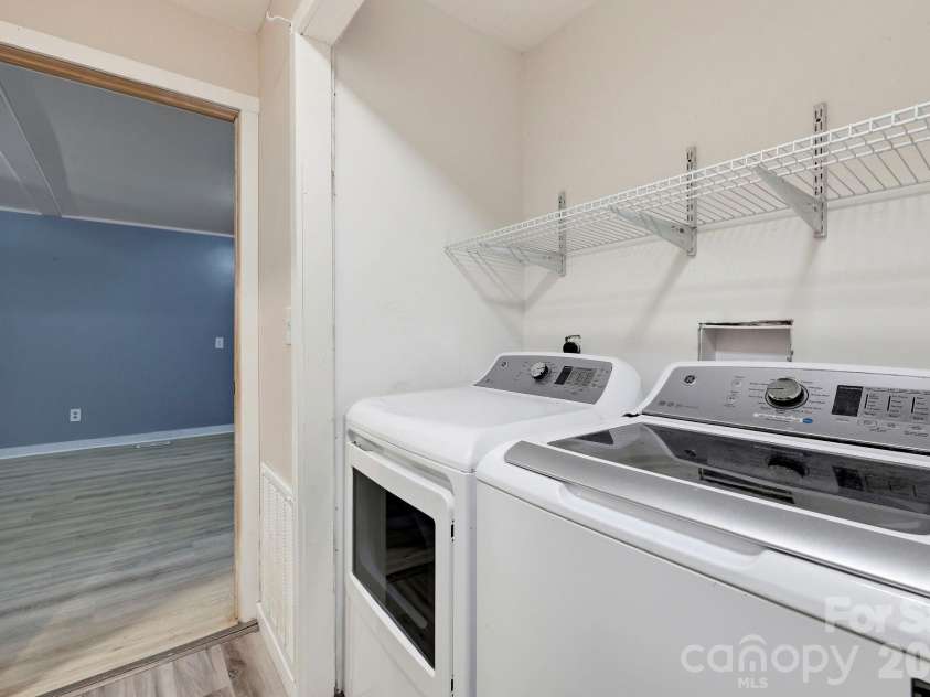 36 Medlin Lane, Flat Rock, NC 28731.  MLS# CAR4428597, YatesRealty ID 53594. Dedicated laundry area with washer and dryer hookups plus overhead shelving for storage.