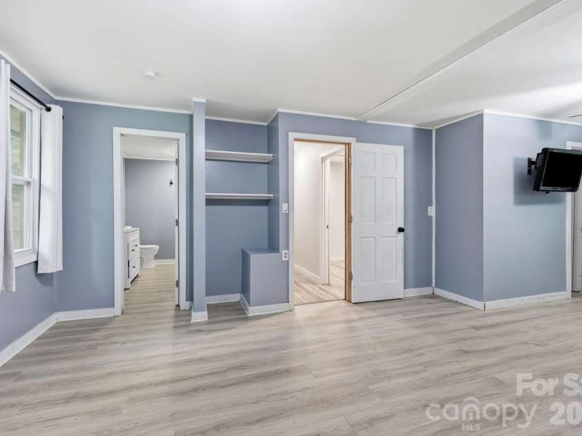 36 Medlin Lane, Flat Rock, NC 28731.  MLS# CAR4428597, YatesRealty ID 53594. Expansive primary bedroom with direct access to the private en-suite bath.