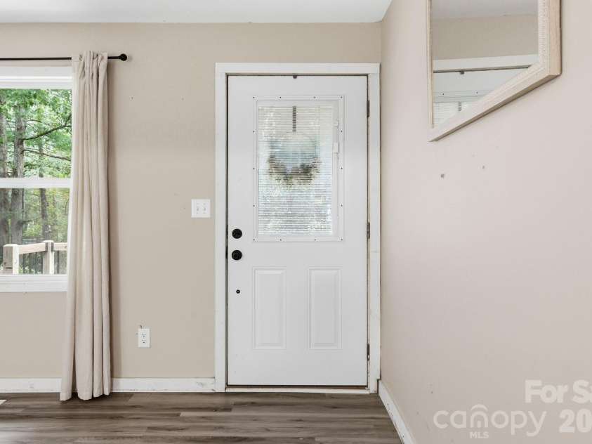36 Medlin Lane, Flat Rock, NC 28731.  MLS# CAR4428597, YatesRealty ID 53594. Front entry opens into a bright living room with durable wood-look flooring.