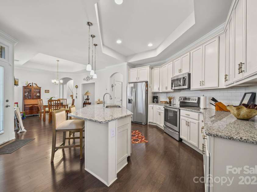 4516 Ideal Way, Harrisburg, NC 28075.  MLS# CAR4325804, YatesRealty ID 536. The Large Kitchen Island Features an Eat-In Bar