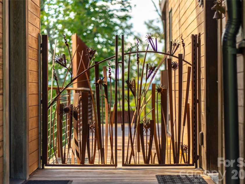 34 Bee Balm Way, Asheville, NC 28804.  MLS# CAR4420482, YatesRealty ID 53633. Custom iron work gate with flower motif.