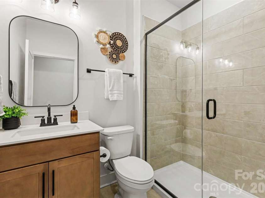7513 Bainbridge Road, Sherrills Ford, NC 28673.  MLS# CAR4425018, YatesRealty ID 53654. Main level guest bath with walk-in tiled shower