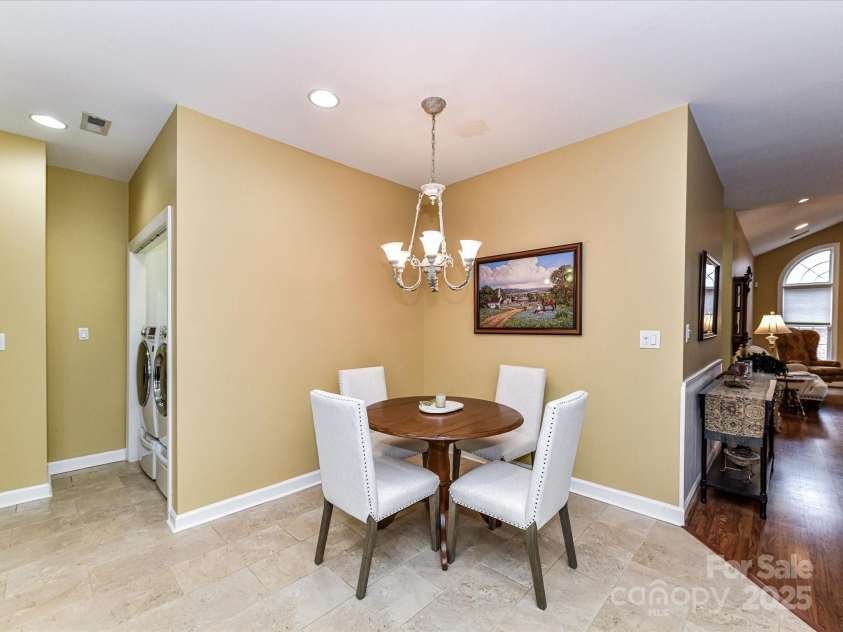 11406 Olde Turnbury Court, Charlotte, NC 28277.  MLS# CAR4233679, YatesRealty ID 5369. Lovely Breakfast/Dining area under the chandelier.