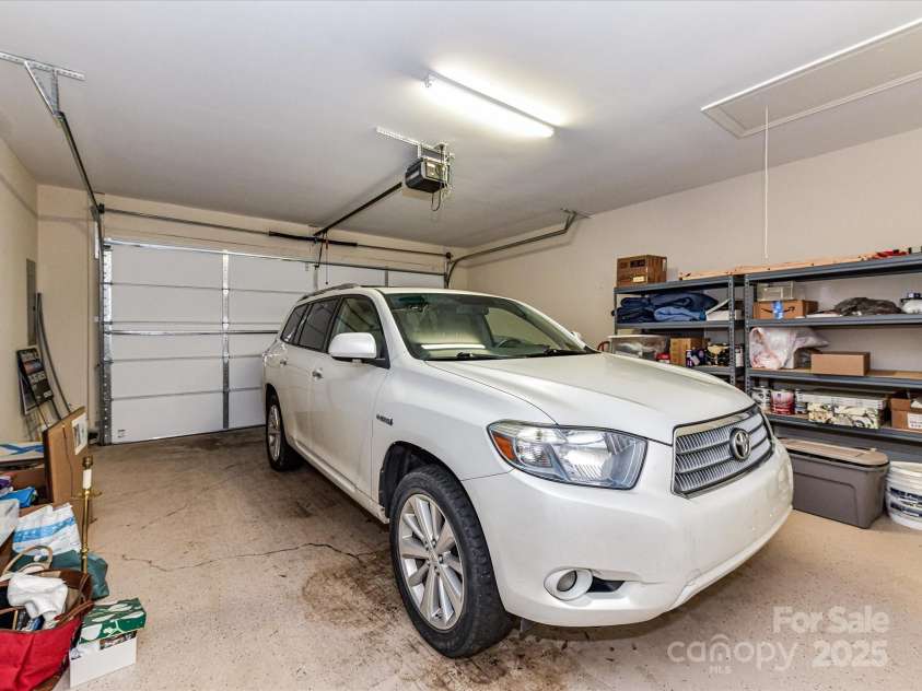 11406 Olde Turnbury Court, Charlotte, NC 28277.  MLS# CAR4233679, YatesRealty ID 5369. Two-car garage with Walk-in storage room, shelving & mounted cabinetry to convey. Exterior Keypad- pull down steps for attic storage.