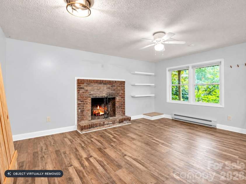 697 Courtney Drive, Hendersonville, NC 28792.  MLS# CAR4429227, YatesRealty ID 53752. Burning logs virtually enhanced. basement bonus room/den