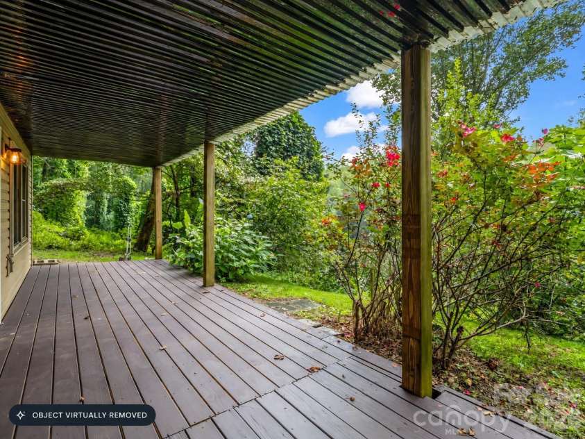 697 Courtney Drive, Hendersonville, NC 28792.  MLS# CAR4429227, YatesRealty ID 53752. Lower level deck. private and lush setting