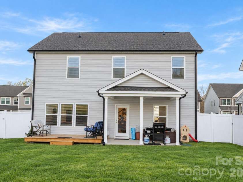 106 Stonewater Drive, Stanfield, NC 28163.  MLS# CAR4422919, YatesRealty ID 53764. Relaxing covered patio with ceiling fan and attached deck