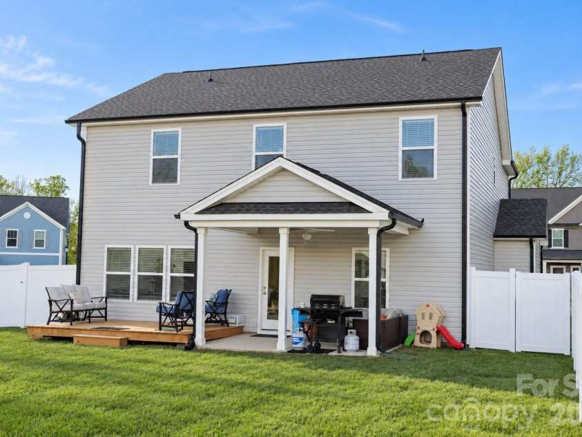 106 Stonewater Drive, Stanfield, NC 28163.  MLS# CAR4422919, YatesRealty ID 53764. Relaxing covered patio with ceiling fan and attached deck