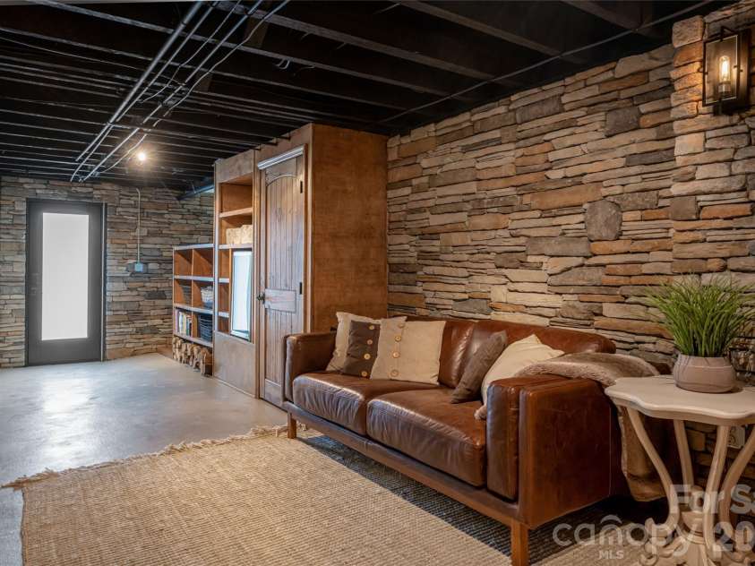 3 Maplewood Parkway, Asheville, NC 28804.  MLS# CAR4425655, YatesRealty ID 53767. TV watching area on the lower level