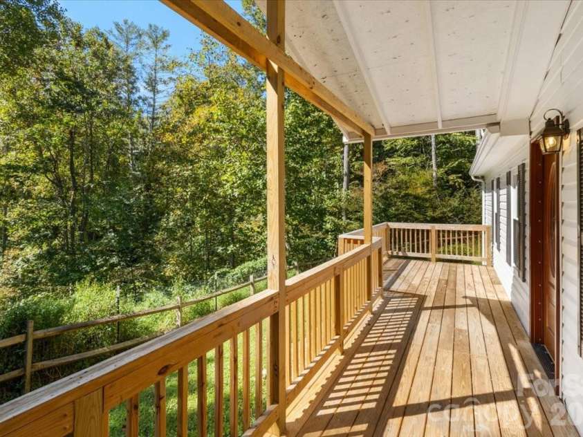 1050 Wyatt Town Road, Burnsville, NC 28714.  MLS# CAR4337141, YatesRealty ID 5377. Relaxing front partially covered deck