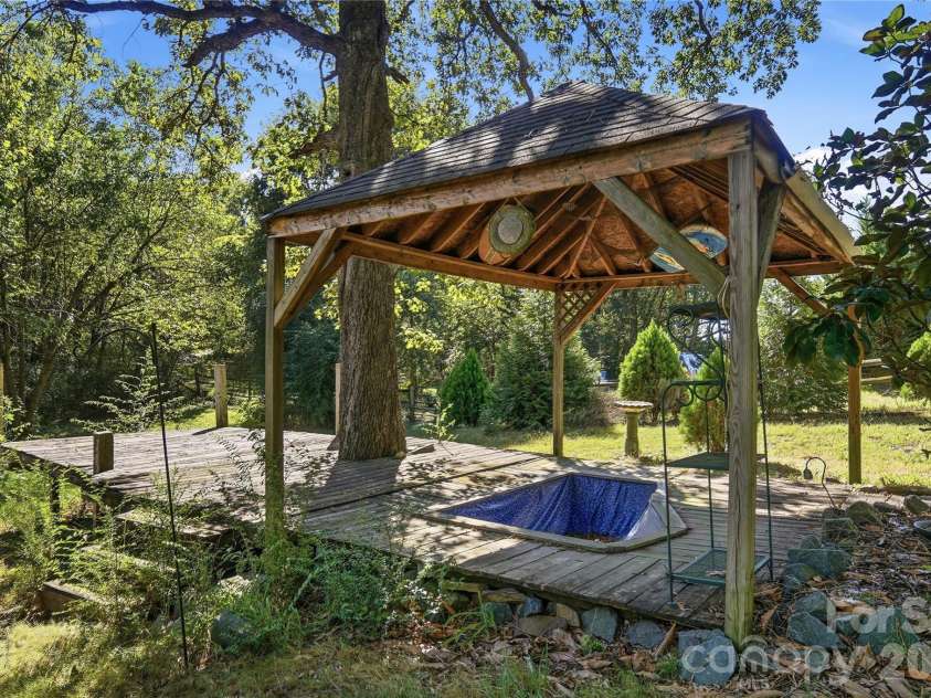 807 218 Highway, Monroe, NC 28110.  MLS# CAR4428091, YatesRealty ID 53786. Empty covered Koi fish pond with a walk-out deck