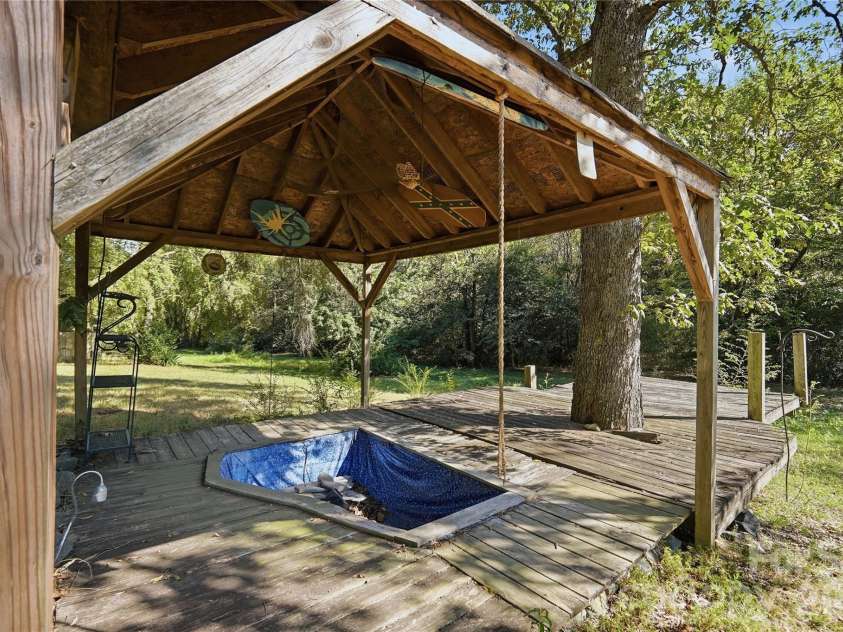 807 218 Highway, Monroe, NC 28110.  MLS# CAR4428091, YatesRealty ID 53786. Empty covered Koi fish pond with a walk-out deck