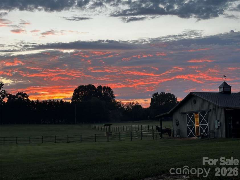 1125 Ballpark Drive, Mooresville, NC 28115.  MLS# CAR4426293, YatesRealty ID 53791. Sunset at barn
