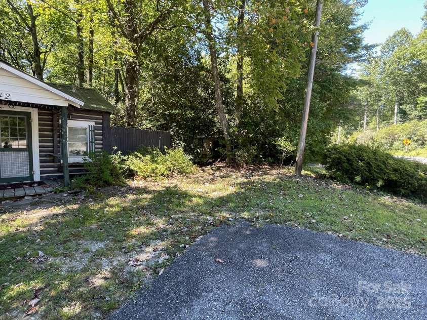 142 Whitewater Road, Sapphire, NC 28774.  MLS# CAR4229231, YatesRealty ID 538. Edge of small home looking toward the second home 