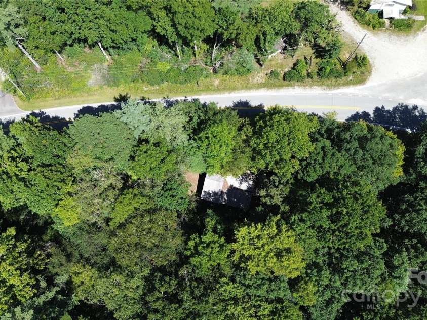 142 Whitewater Road, Sapphire, NC 28774.  MLS# CAR4229231, YatesRealty ID 538. This shows the small home and road frontage. 