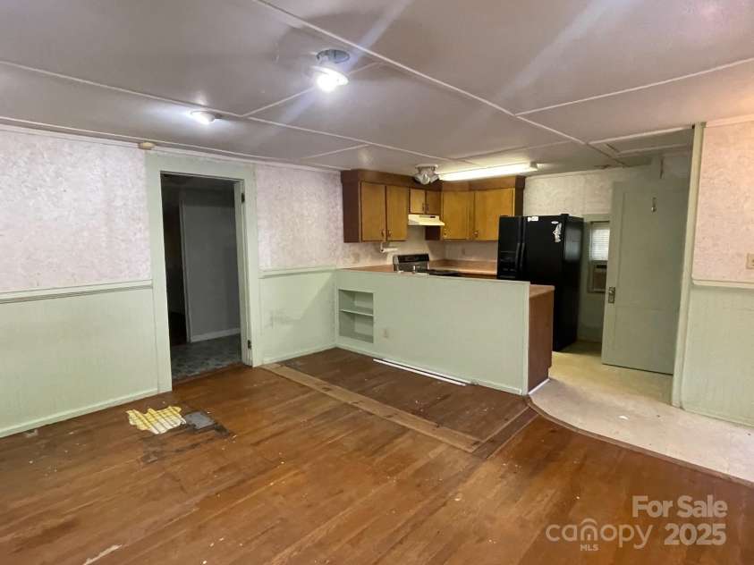 142 Whitewater Road, Sapphire, NC 28774.  MLS# CAR4229231, YatesRealty ID 538. View in small home of living room looking into the kitchen 