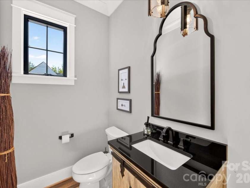 416 Woodland Street, Davidson, NC 28036.  MLS# CAR4425891, YatesRealty ID 53849. Half bath with beautiful mirror and vanity sink