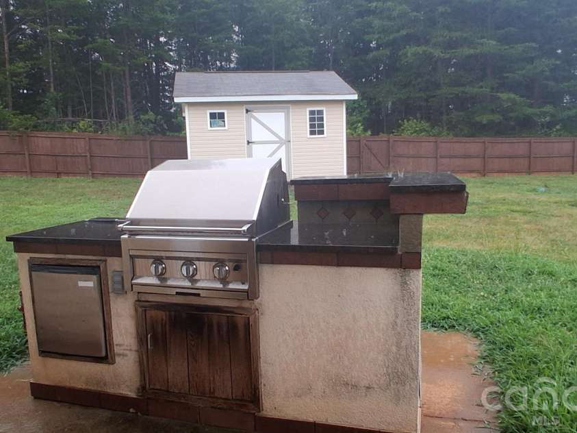 1148 Crowders Woods Drive, Gastonia, NC 28052.  MLS# CAR4403106, YatesRealty ID 53914. Outside Grill and storage