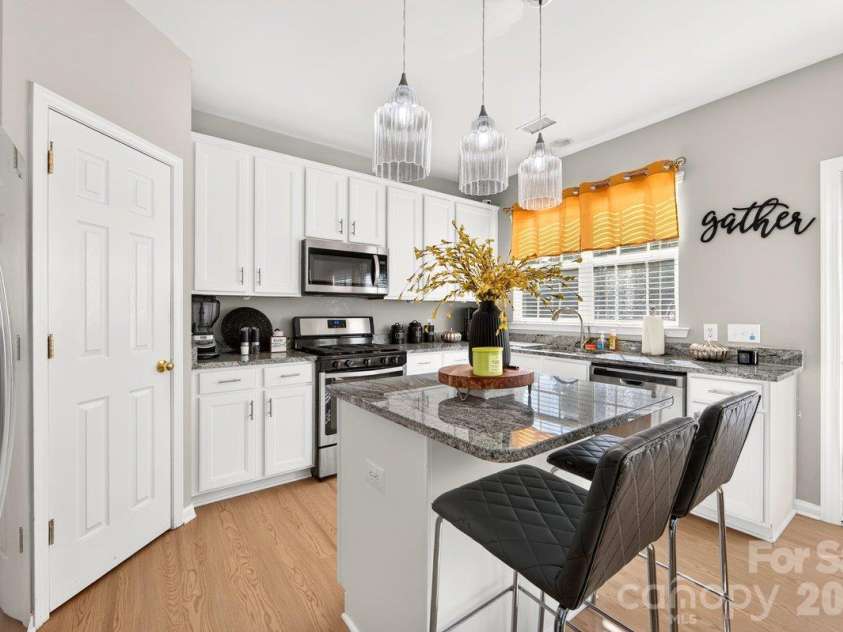 10536 Adlin Avenue, Charlotte, NC 28262.  MLS# CAR4429740, YatesRealty ID 53922. Kitchen island and painted white cabinets.