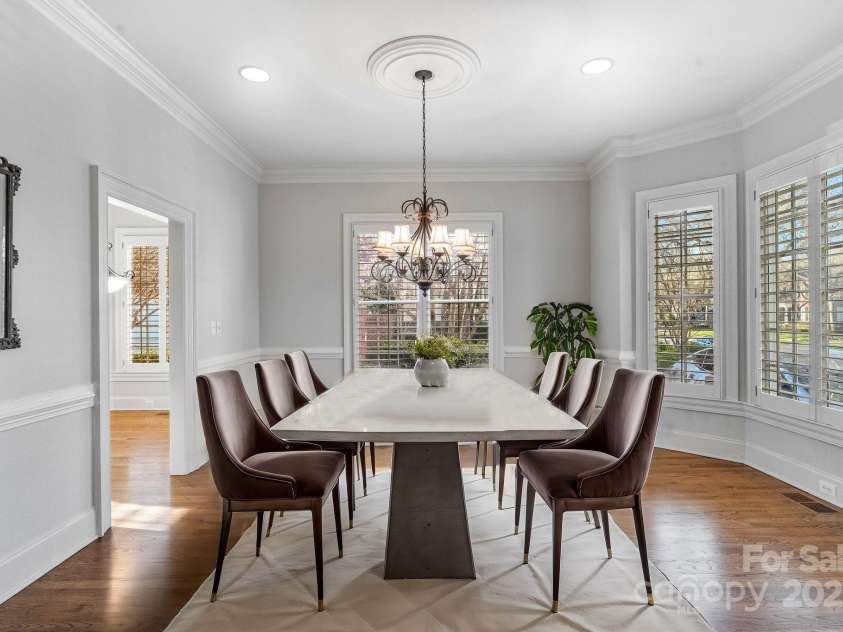 1131 Kings Drive, Charlotte, NC 28207.  MLS# CAR4235522, YatesRealty ID 5393. Entertain family and friends on holidays and special occasions in the lovely formal Dining Room with bay window, chair and crown moldings, recessed lighting, and beautiful chandelier. (Staged virtually)
