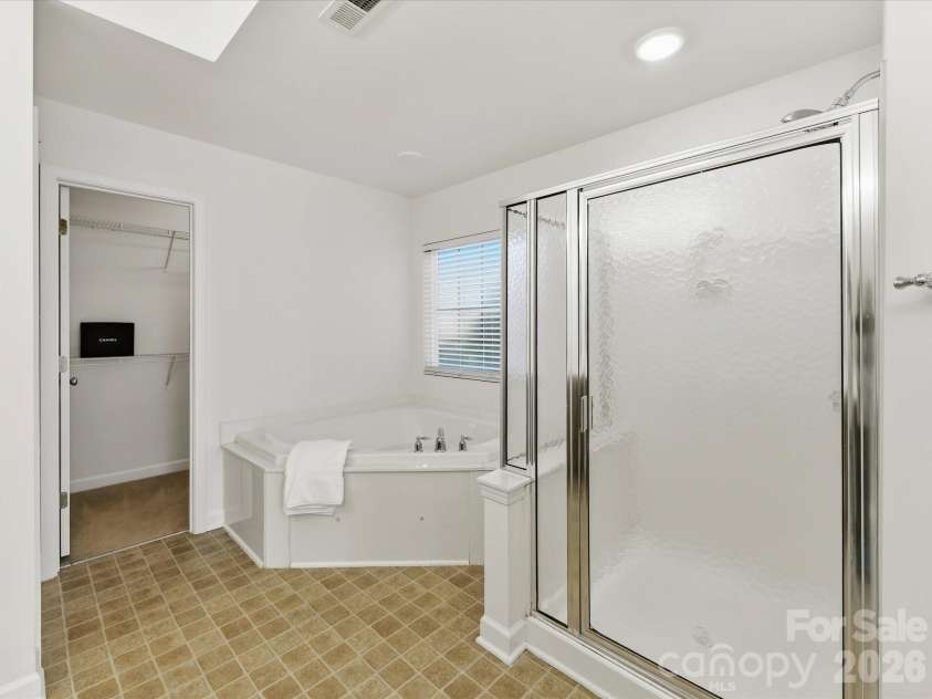 8128 Madrigal Court, Waxhaw, NC 28173.  MLS# CAR4429672, YatesRealty ID 53943. Luxury bath features a jetted tub and Step in shower