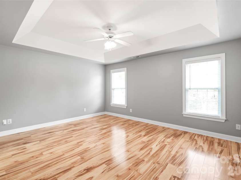 2008 Trace Creek Drive, Waxhaw, NC 28173.  MLS# CAR4428166, YatesRealty ID 53969. A clean slate full of potential! This spacious main-level primary bedroom features dramatic trey ceilings and durable LVP flooring.