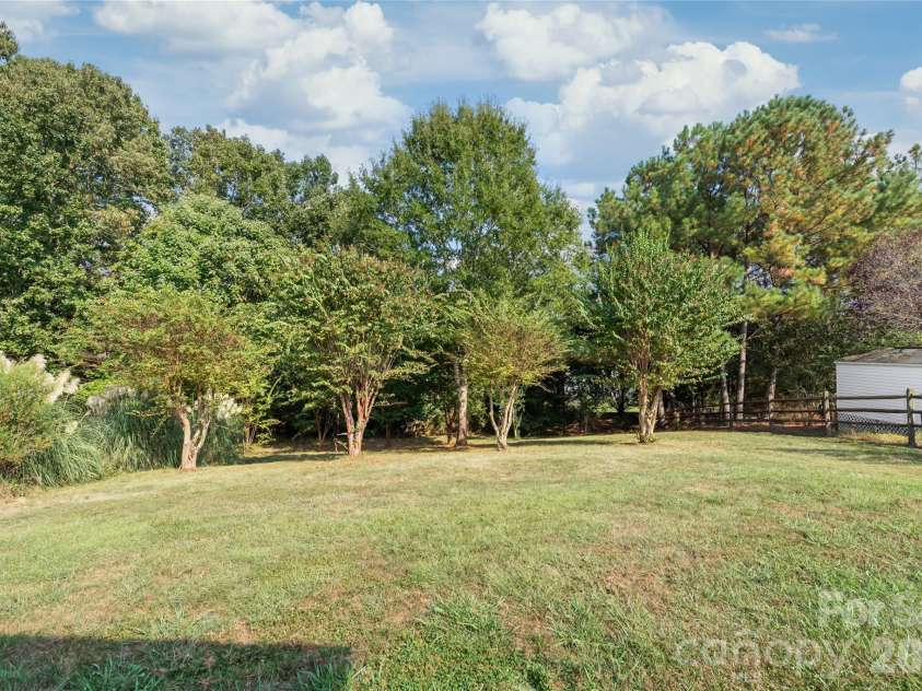 2008 Trace Creek Drive, Waxhaw, NC 28173.  MLS# CAR4428166, YatesRealty ID 53969. Framed by a serene, tree-lined view, the private wooded backdrop creates a quiet natural sanctuary right outside your back door.