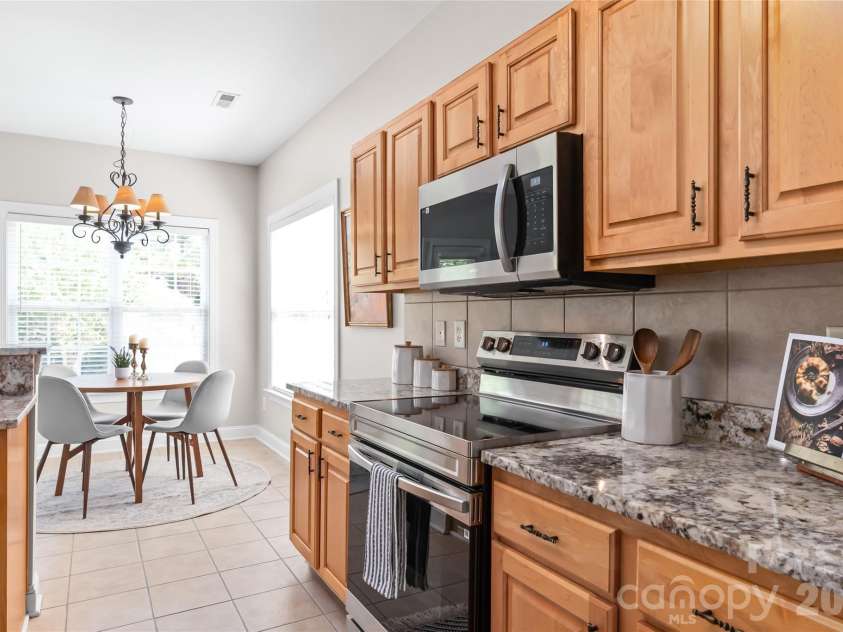 2008 Trace Creek Drive, Waxhaw, NC 28173.  MLS# CAR4428166, YatesRealty ID 53969. Fully equipped for everyday meals and weekend entertaining, the kitchen features an electric range and oven paired with a convenient built-in microwave for seamless prep and cooking.