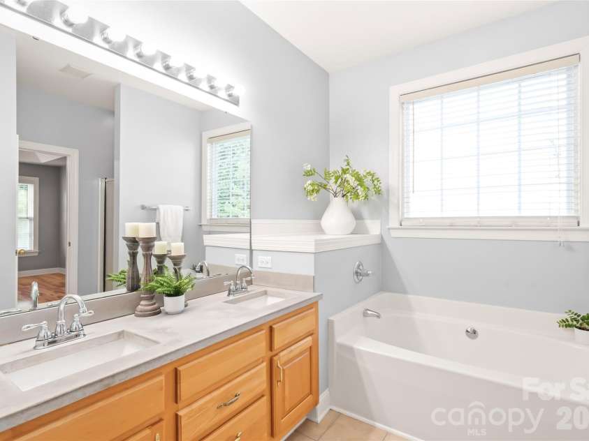 2008 Trace Creek Drive, Waxhaw, NC 28173.  MLS# CAR4428166, YatesRealty ID 53969. The primary ensuite boasts updated countertops, sleek double sinks with ample prep space, and garden tub.