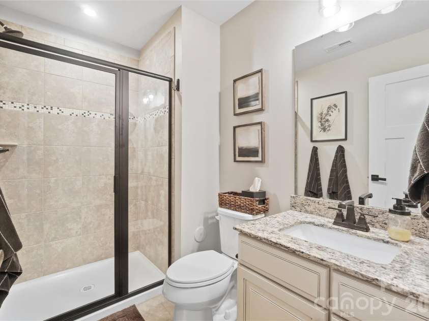 912 Manorwood Drive, Waxhaw, NC 28173.  MLS# CAR4427277, YatesRealty ID 53979. Main-level full bath with a walk-in tile shower and granite vanity, steps from the study.