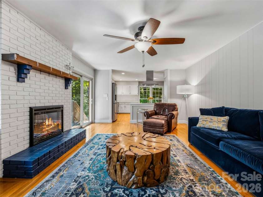 531 Bluebird Ridge, Asheville, NC 28804.  MLS# CAR4424625, YatesRealty ID 53994. Den with fireplace and deck access off kitchen.