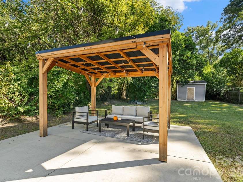 233 Marion Street, Rock Hill, SC 29730.  MLS# CAR4415460, YatesRealty ID 54008. Covered pergola with string lights conveys