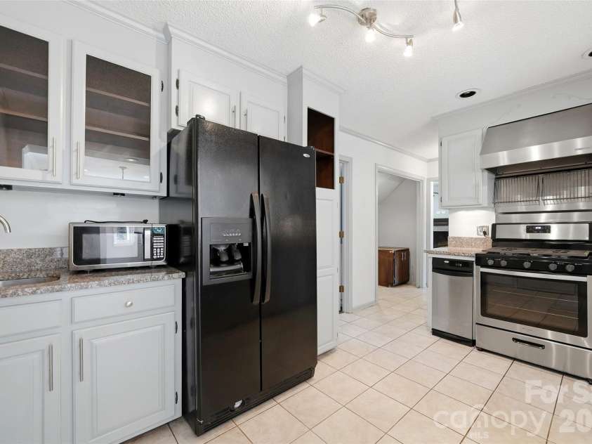 2351 Ellerbe Drive, Kannapolis, NC 28083.  MLS# CAR4430208, YatesRealty ID 54016. Kitchen with gas range, vent hood and refrigerator