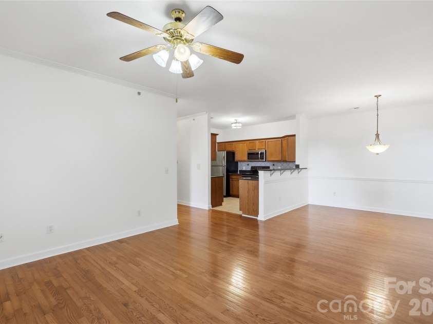 16406 Redstone Mountain Lane, Charlotte, NC 28277.  MLS# CAR4429830, YatesRealty ID 54019. Living area looking into dinning room and kitchen
