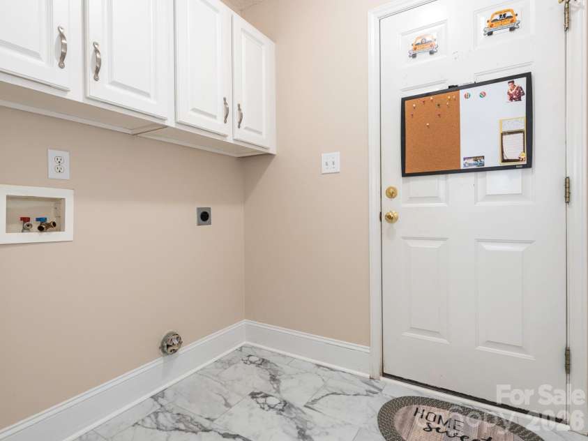 8415 Quail Hollow Drive, Harrisburg, NC 28075.  MLS# CAR4424111, YatesRealty ID 54022. Laundry room