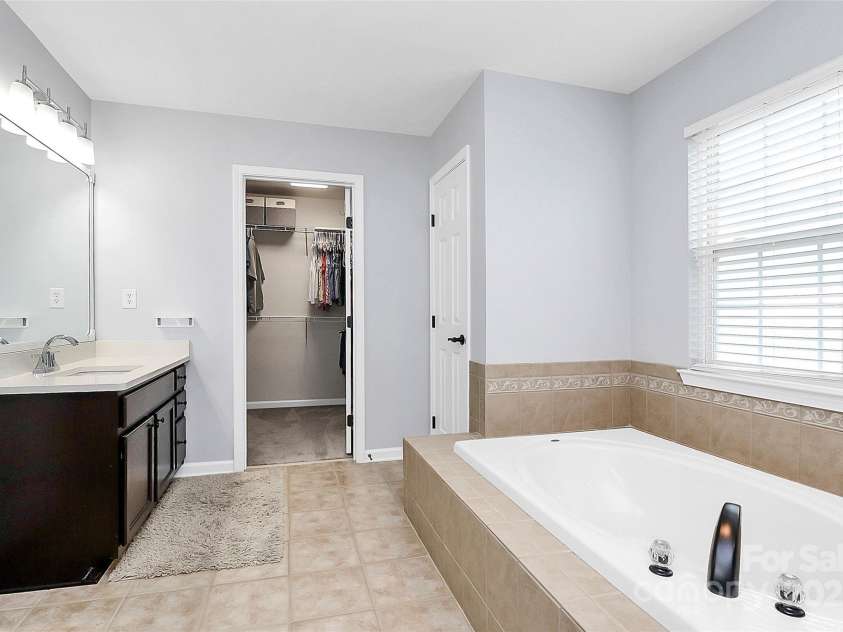 4086 Buckingham Drive, Fort Mill, SC 29707.  MLS# CAR4243764, YatesRealty ID 5404. 3rd view of primary bath with water closet and large closet for all your clothes and shoes