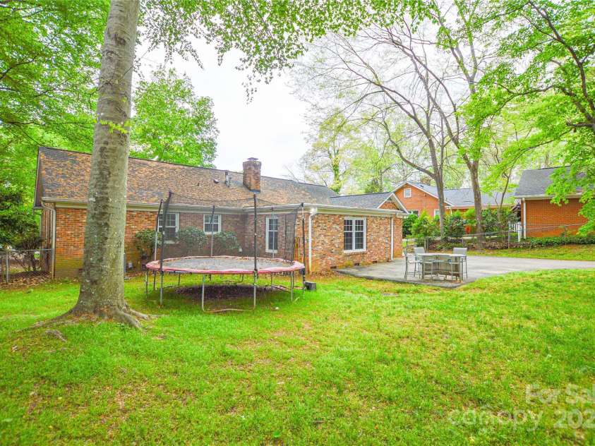 2429 Sugar Mill Road, Charlotte, NC 28210.  MLS# CAR4245721, YatesRealty ID 5405. Another view of the back of the home showing the large yard and driveway.