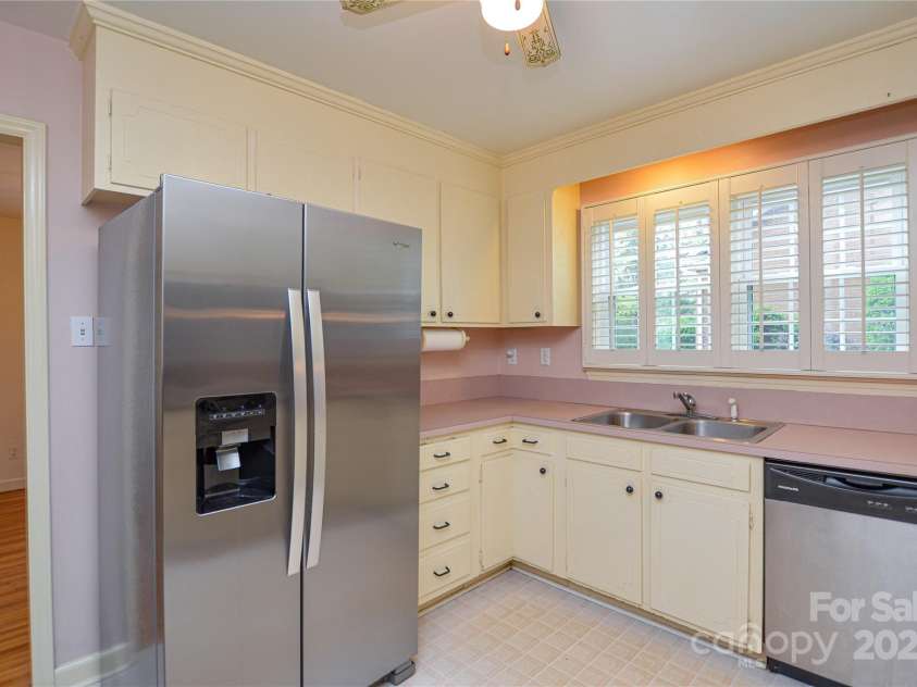 2429 Sugar Mill Road, Charlotte, NC 28210.  MLS# CAR4245721, YatesRealty ID 5405. Another view of the Kitchen showing SS appliances, bright views from the windows, and classic cabinets.