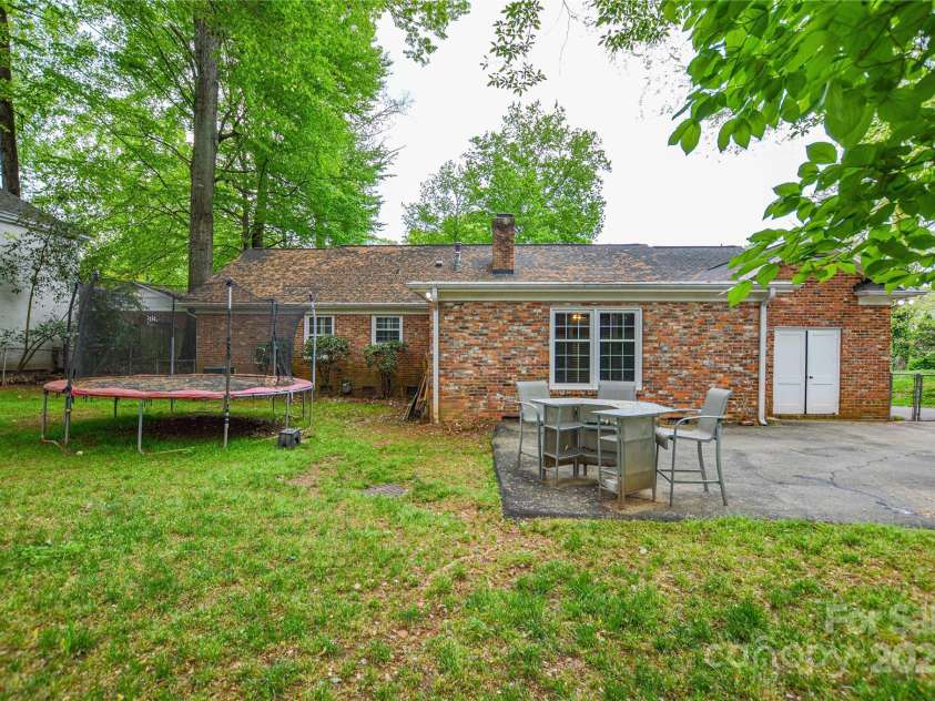 2429 Sugar Mill Road, Charlotte, NC 28210.  MLS# CAR4245721, YatesRealty ID 5405. Back of the home showing the large fenced in yard, storage outparcel, and long driveway.