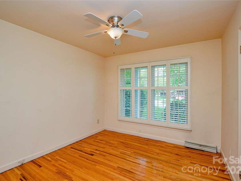 2429 Sugar Mill Road, Charlotte, NC 28210.  MLS# CAR4245721, YatesRealty ID 5405. Bedroom 1 has warm hardwood flooring, ceiling fan and custom plantation shutters.