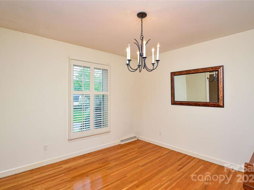 2429 Sugar Mill Road, Charlotte, NC 28210.  MLS# CAR4245721, YatesRealty ID 5405. Formal Dining Room has fixture, plantation shutters and classic warm hardwood flooring.