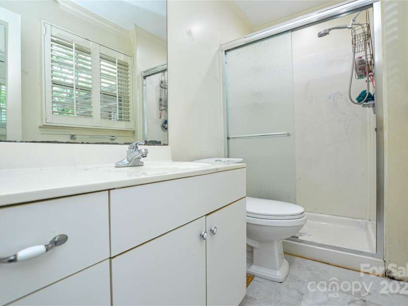 2429 Sugar Mill Road, Charlotte, NC 28210.  MLS# CAR4245721, YatesRealty ID 5405. Primary bathroom showing vanity, commode and shower.
