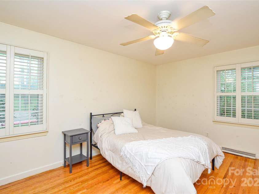 2429 Sugar Mill Road, Charlotte, NC 28210.  MLS# CAR4245721, YatesRealty ID 5405. Primary Bedroom has warm hardwood flooring and bright views from windows with custom plantation shutters.