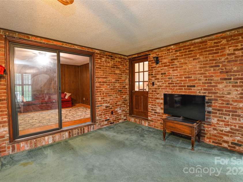 2429 Sugar Mill Road, Charlotte, NC 28210.  MLS# CAR4245721, YatesRealty ID 5405. Recreation room looking towards the home showing the sliding glass doors and door leading into the Eat in Kitchen area.